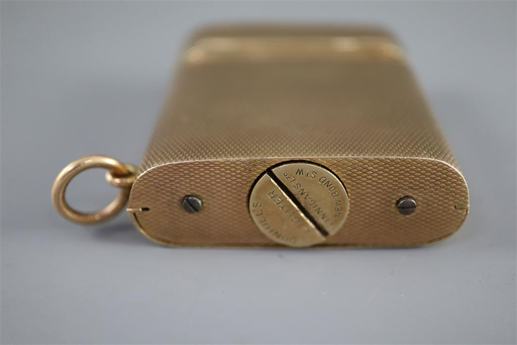 A 1920s engined turned 9ct gold mounted Dunhill lighter, by Finnigans Ltd, London, 1928,